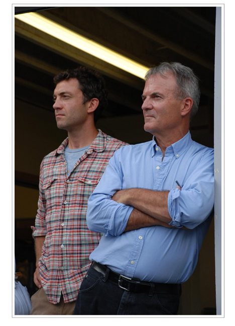 Saer and Bill Huston look on as Bill's brother, Bob, talks at the company's 25th anniversary.